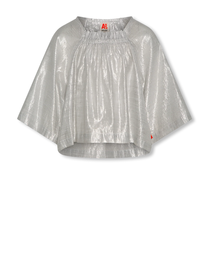 Silver metallic blouse with a brand label on a white background