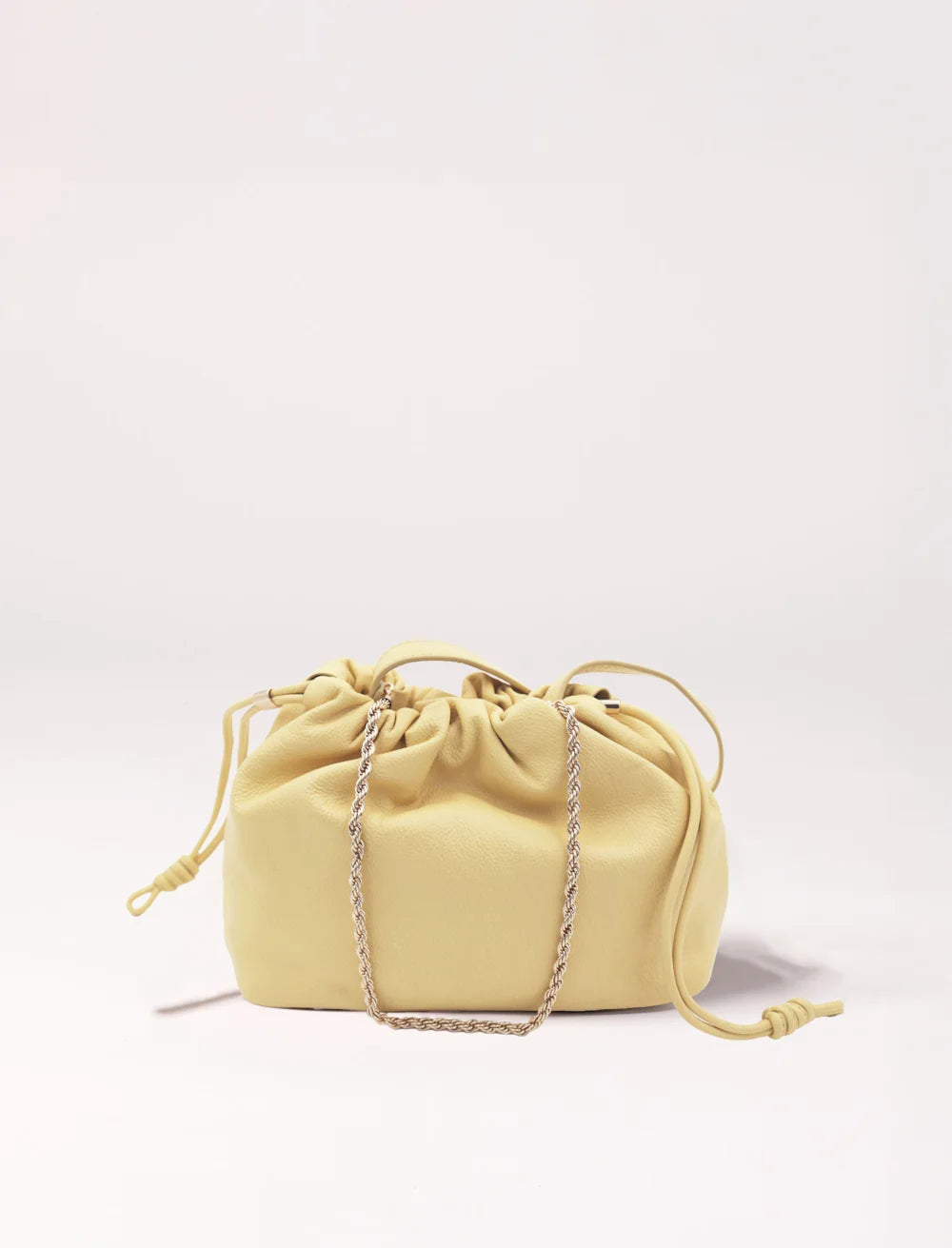 soft leather pouch bag with drawstring closure and gold chain strap