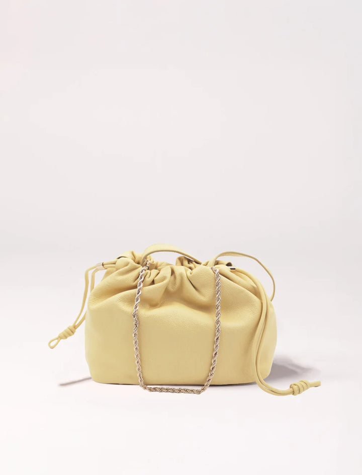 soft leather pouch bag with drawstring closure and gold chain strap