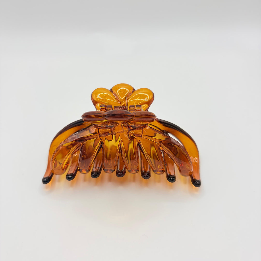 Ambra amber hair claw by Beebop with translucent honey finish and floral-inspired design