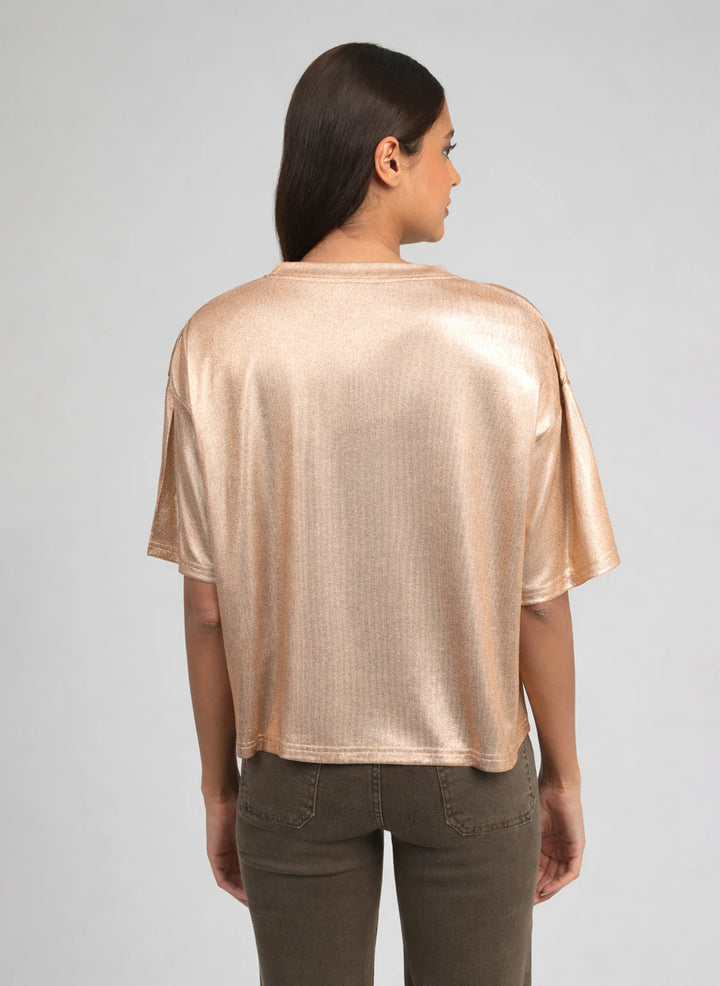 Woman wearing the An’ge Akomila gold metallic oversized t-shirt with a relaxed fit and short sleeves.