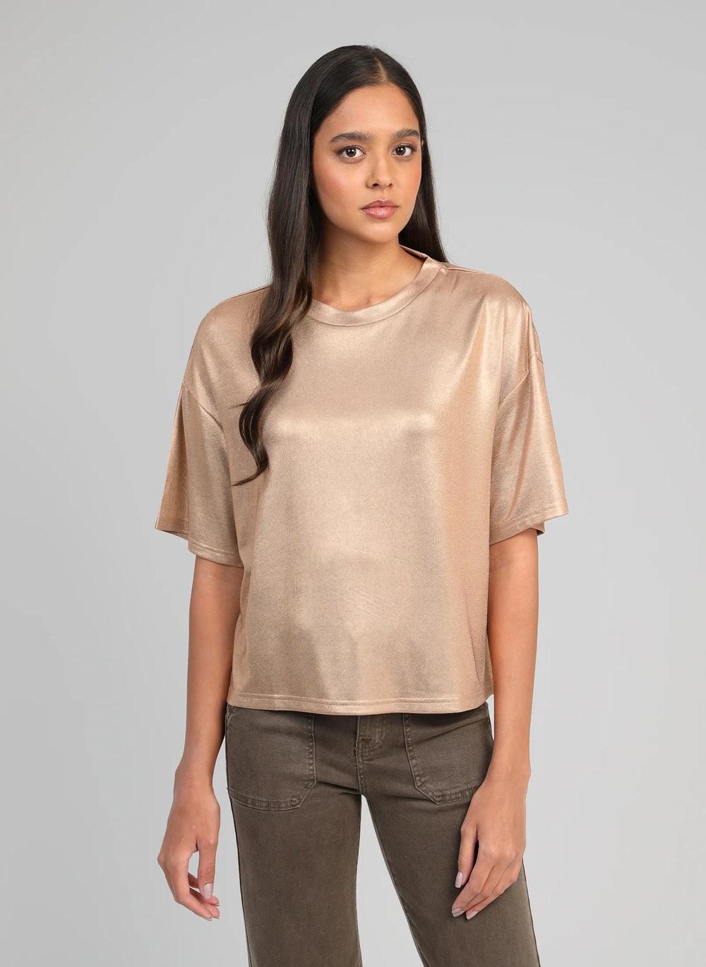 Woman wearing the An’ge Akomila gold metallic oversized t-shirt with a relaxed fit and short sleeves.