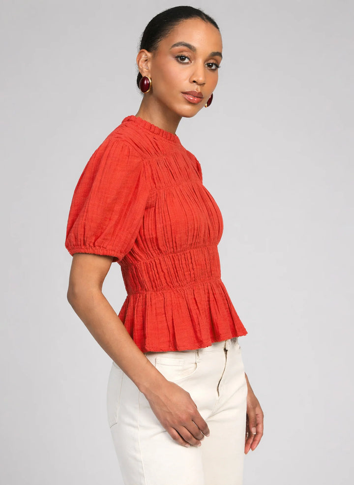 An’ge Sizaya smocked top with puff sleeves and peplum hem in lightweight textured fabric