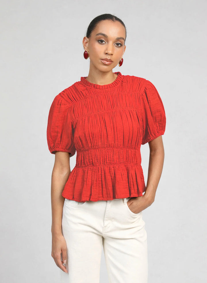 An’ge Sizaya smocked top with puff sleeves and peplum hem in lightweight textured fabric