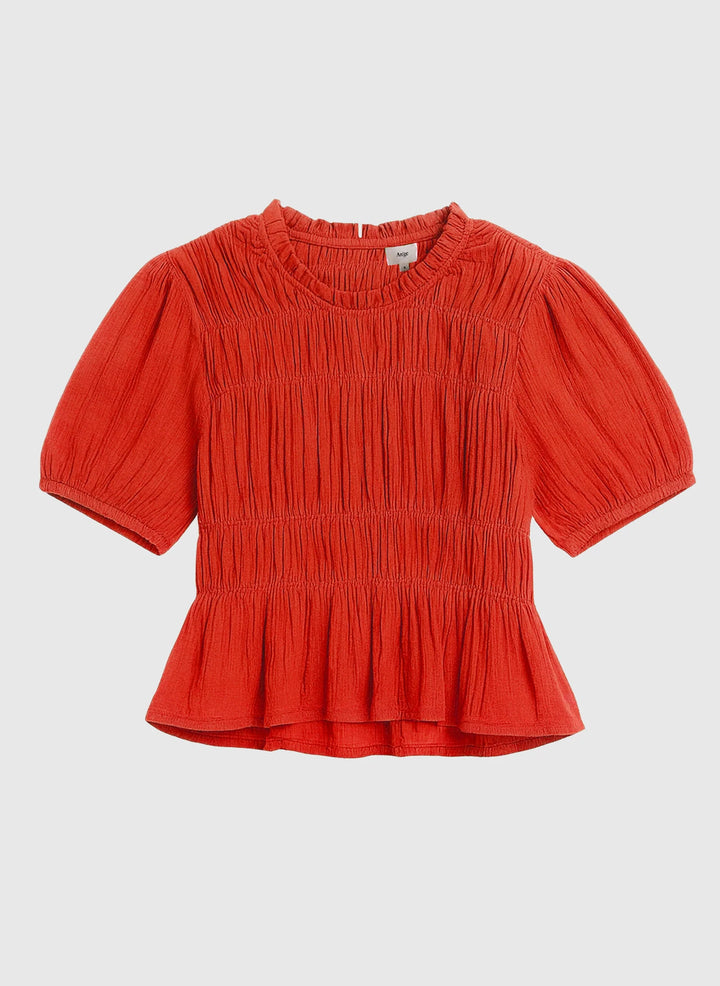 An’ge Sizaya smocked top with puff sleeves and peplum hem in lightweight textured fabric