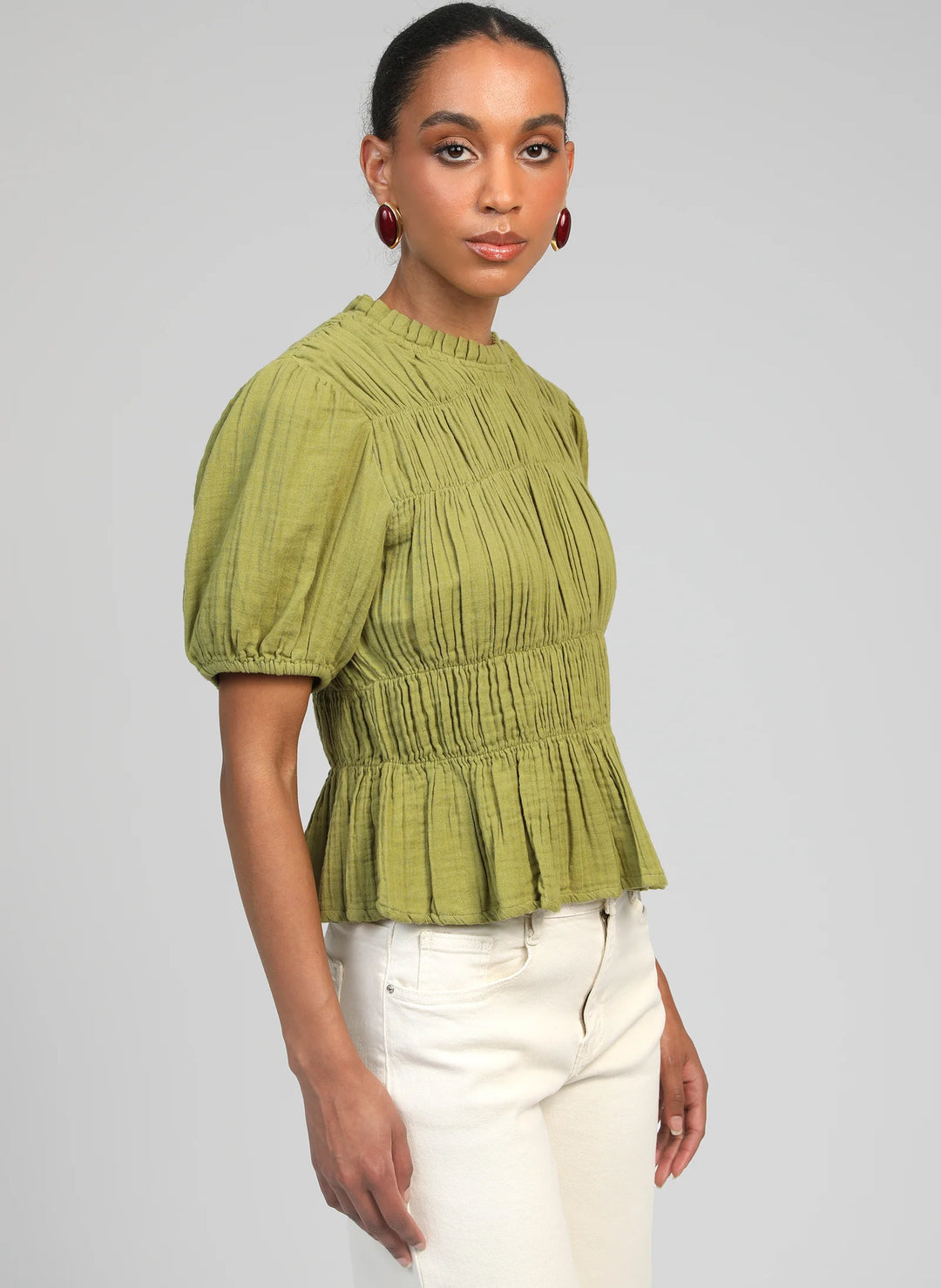 An’ge Sizaya smocked top with puff sleeves and peplum hem in lightweight textured fabric