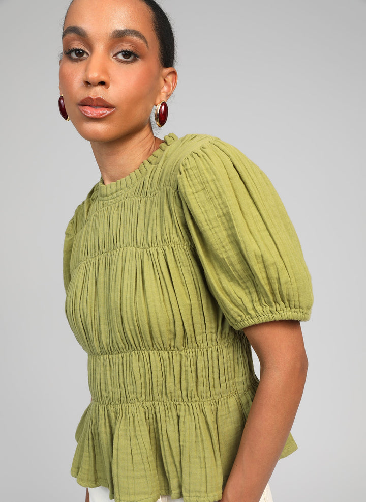 An’ge Sizaya smocked top with puff sleeves and peplum hem in lightweight textured fabric