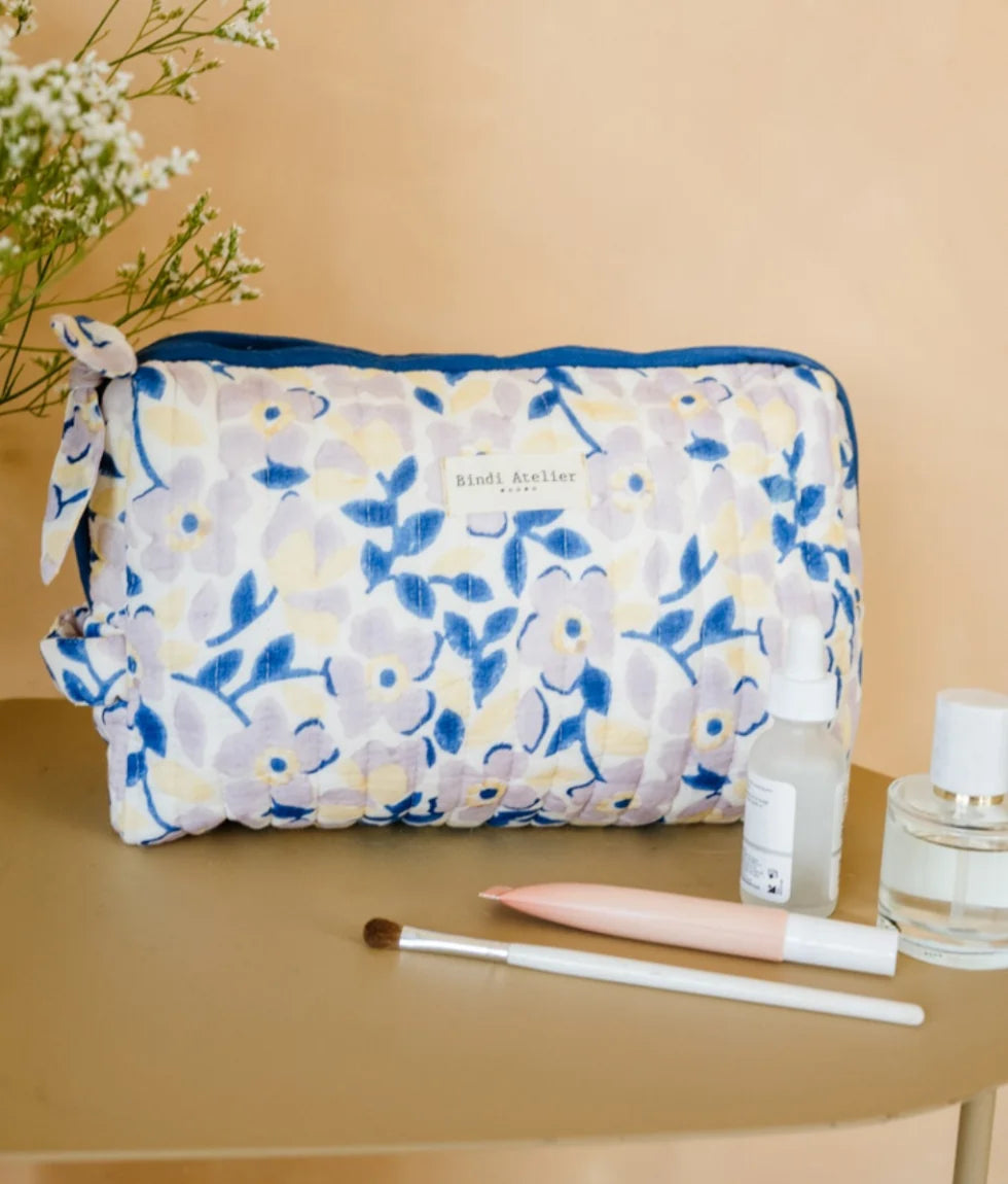 Blue floral quilted beauty pouch by Bindi Atelier with soft botanical print and zip closure