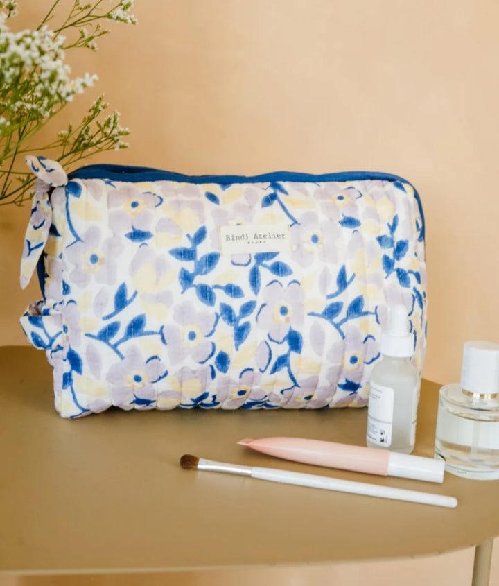 Blue floral quilted beauty pouch by Bindi Atelier with soft botanical print and zip closure