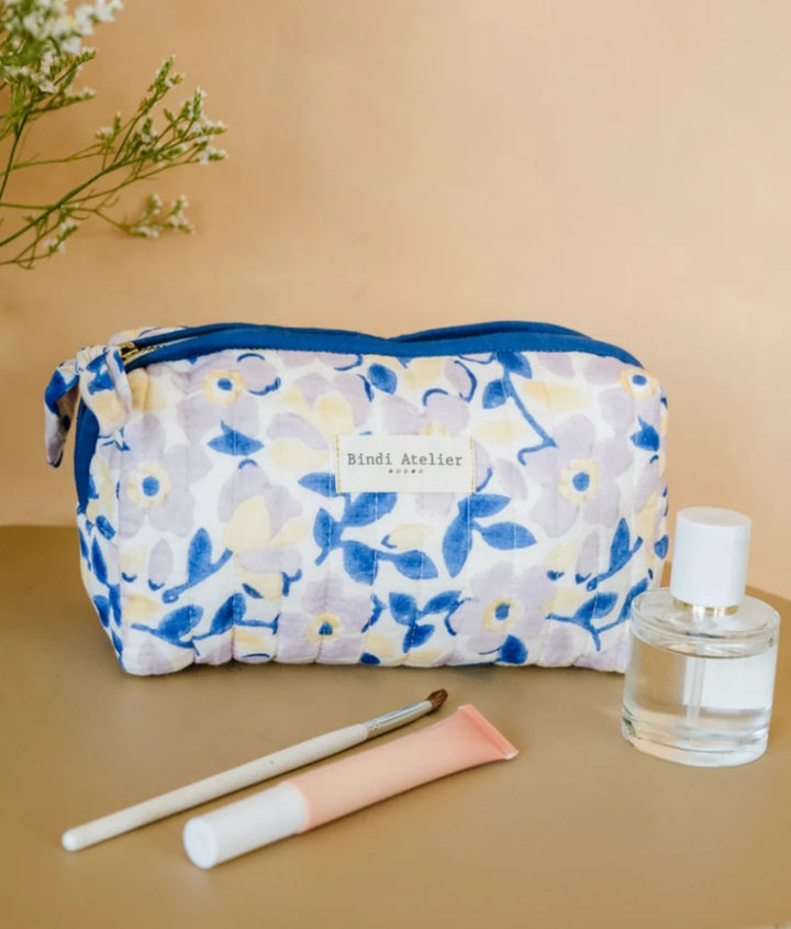 Blue floral quilted beauty pouch by Bindi Atelier with soft botanical print and zip closure