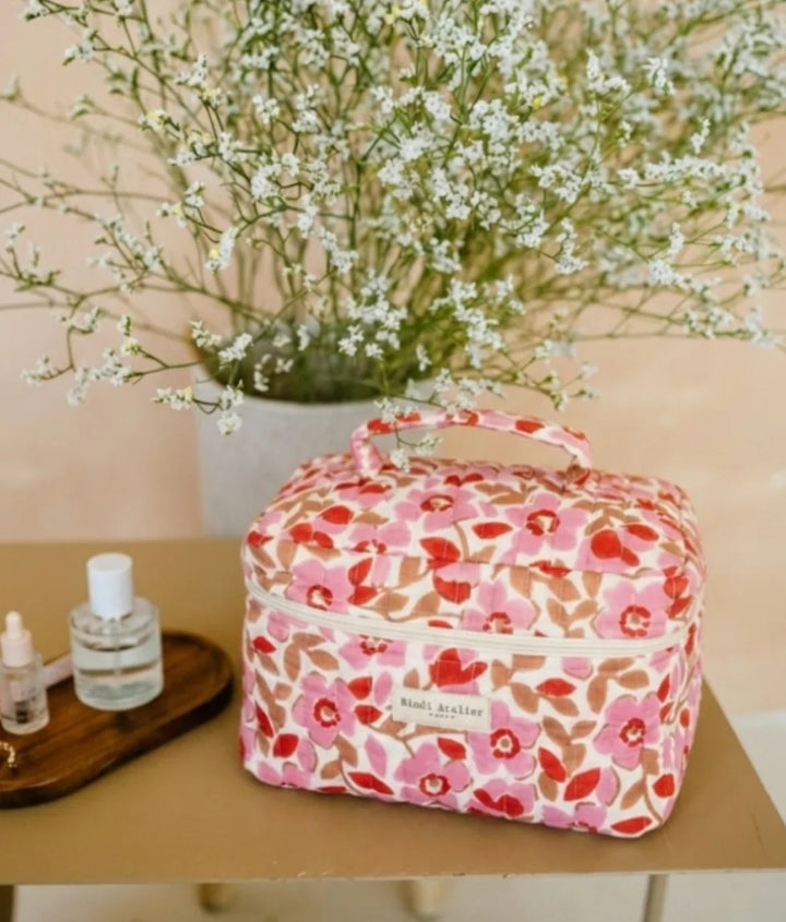 Pink floral quilted vanity case by Bindi Atelier with structured shape and top carry handle