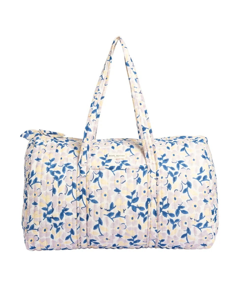 Blue floral quilted cotton weekender bag with soft padded handles and spacious travel design