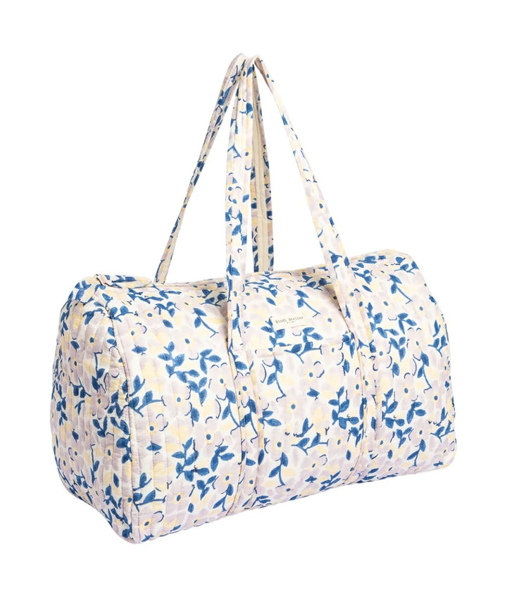Blue floral quilted cotton weekender bag with soft padded handles and spacious travel design