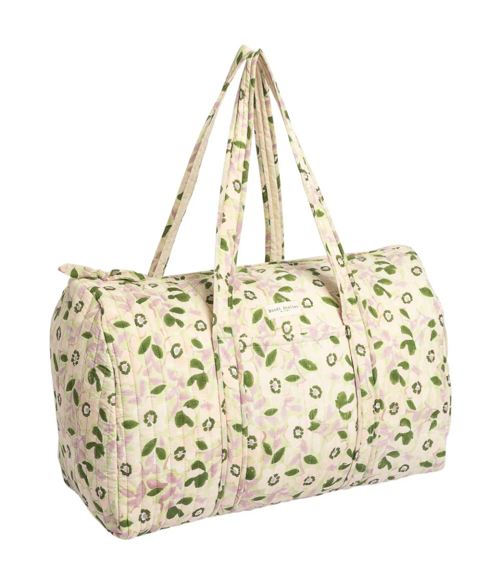 Green floral quilted cotton weekender bag with padded handles and spacious overnight travel design