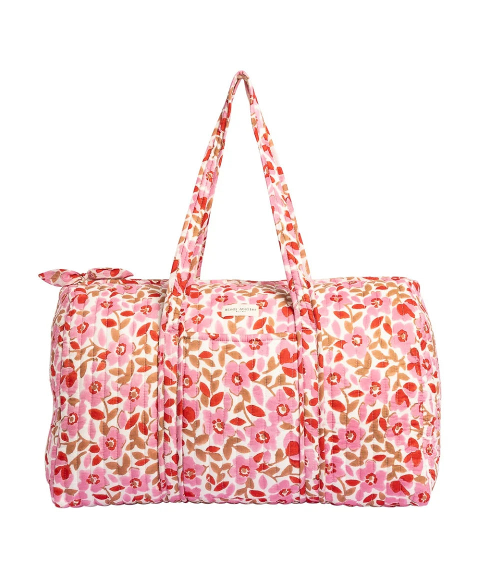 Pink floral quilted cotton weekender bag with padded handles and spacious travel design