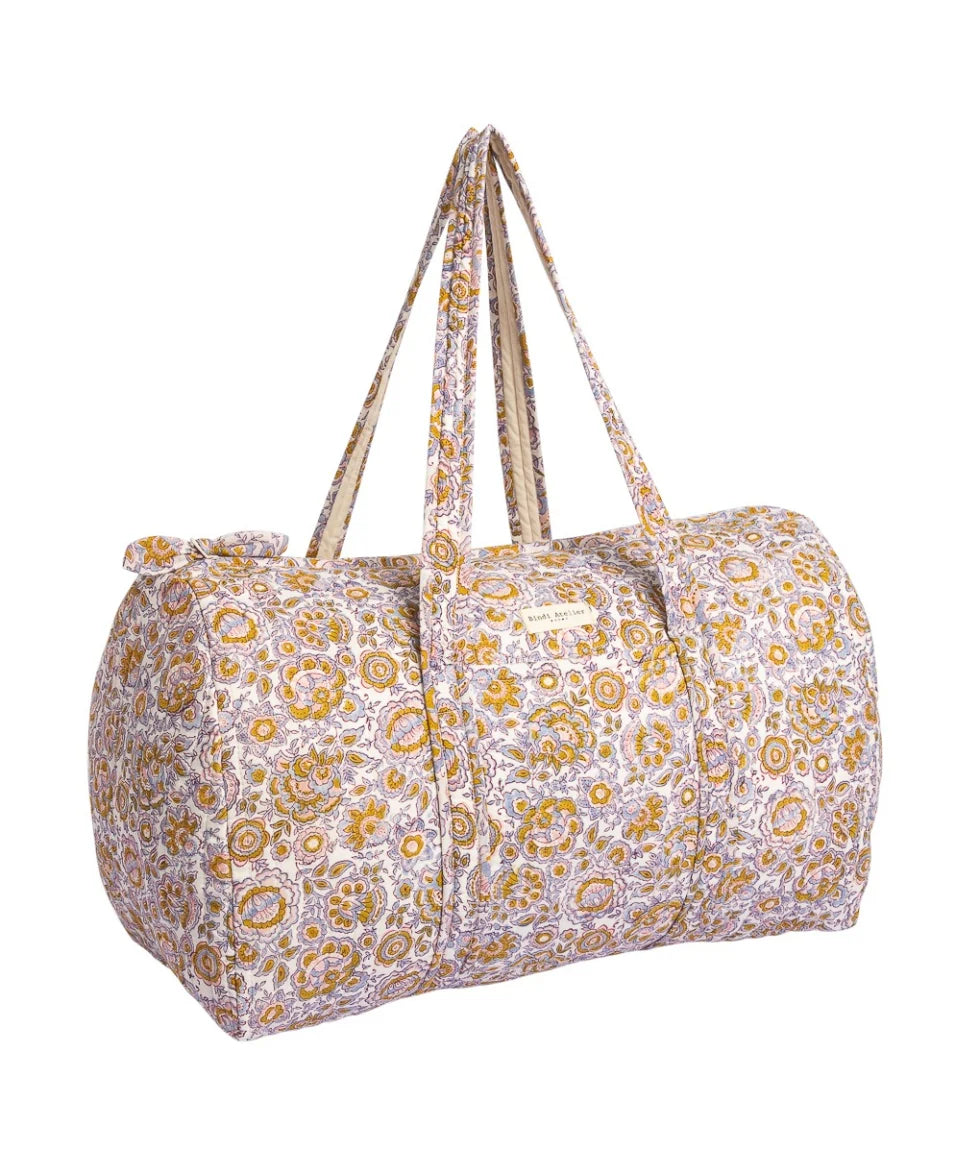 Floral quilted cotton weekender bag with padded handles and spacious overnight travel design