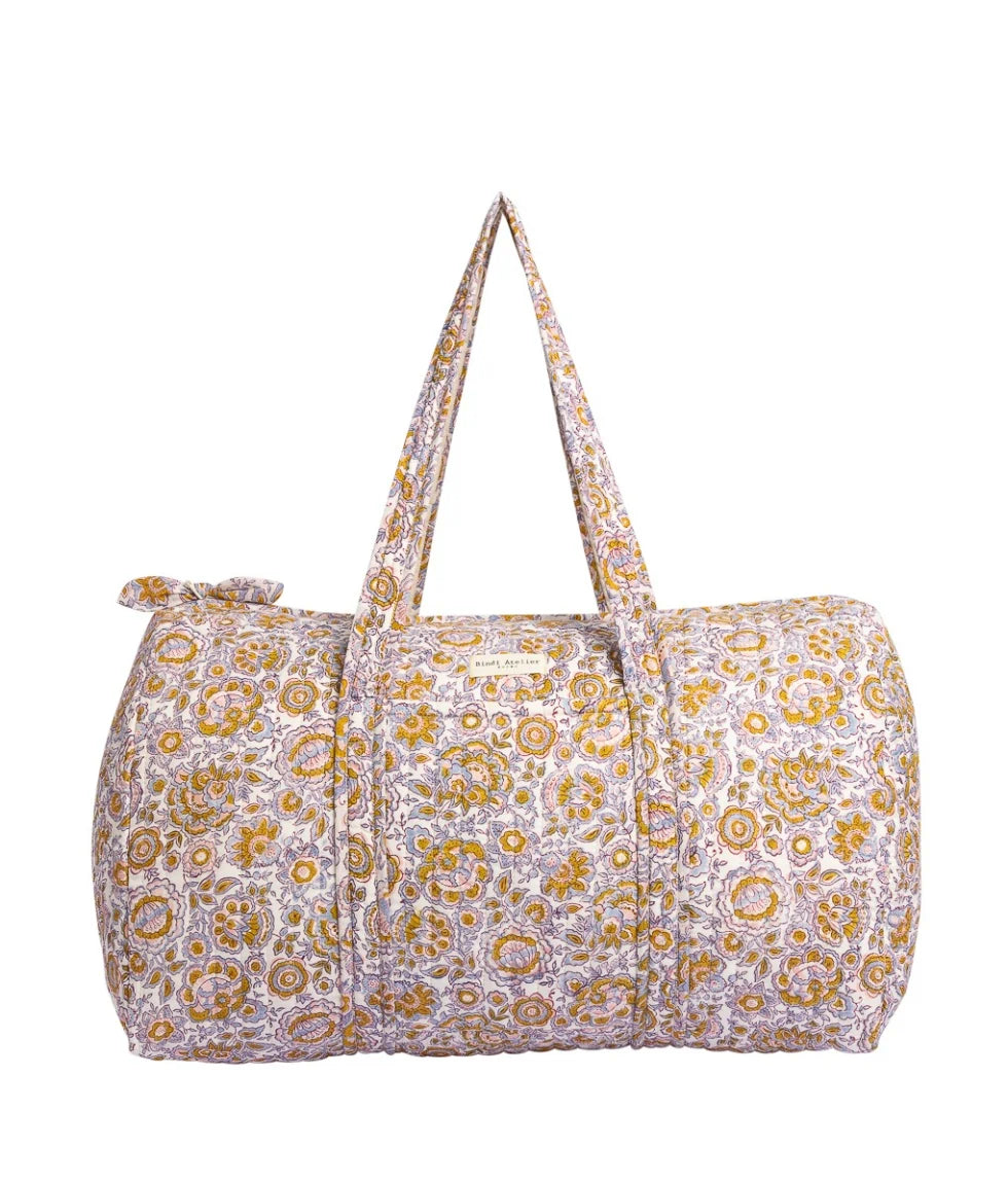 Floral quilted cotton weekender bag with padded handles and spacious overnight travel design