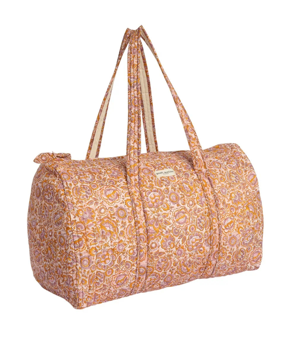 Pink floral quilted cotton weekender bag with padded handles and spacious overnight design