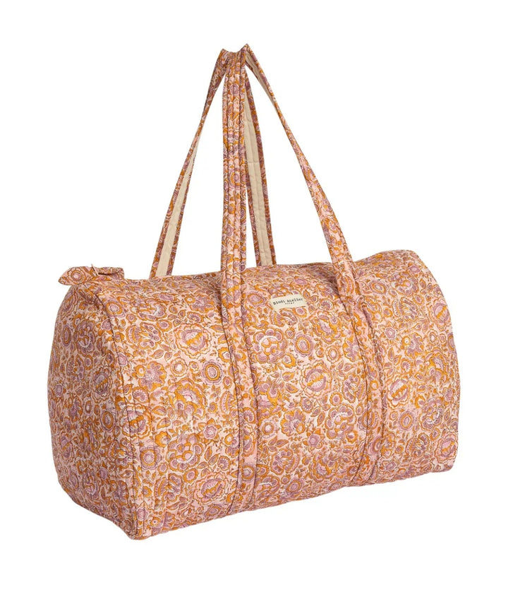 Pink floral quilted cotton weekender bag with padded handles and spacious overnight design