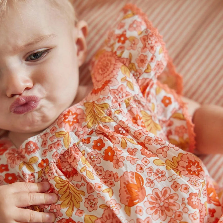 Bonheur du Jour Lionetta ecru rose floral baby romper with ruffle sleeves
