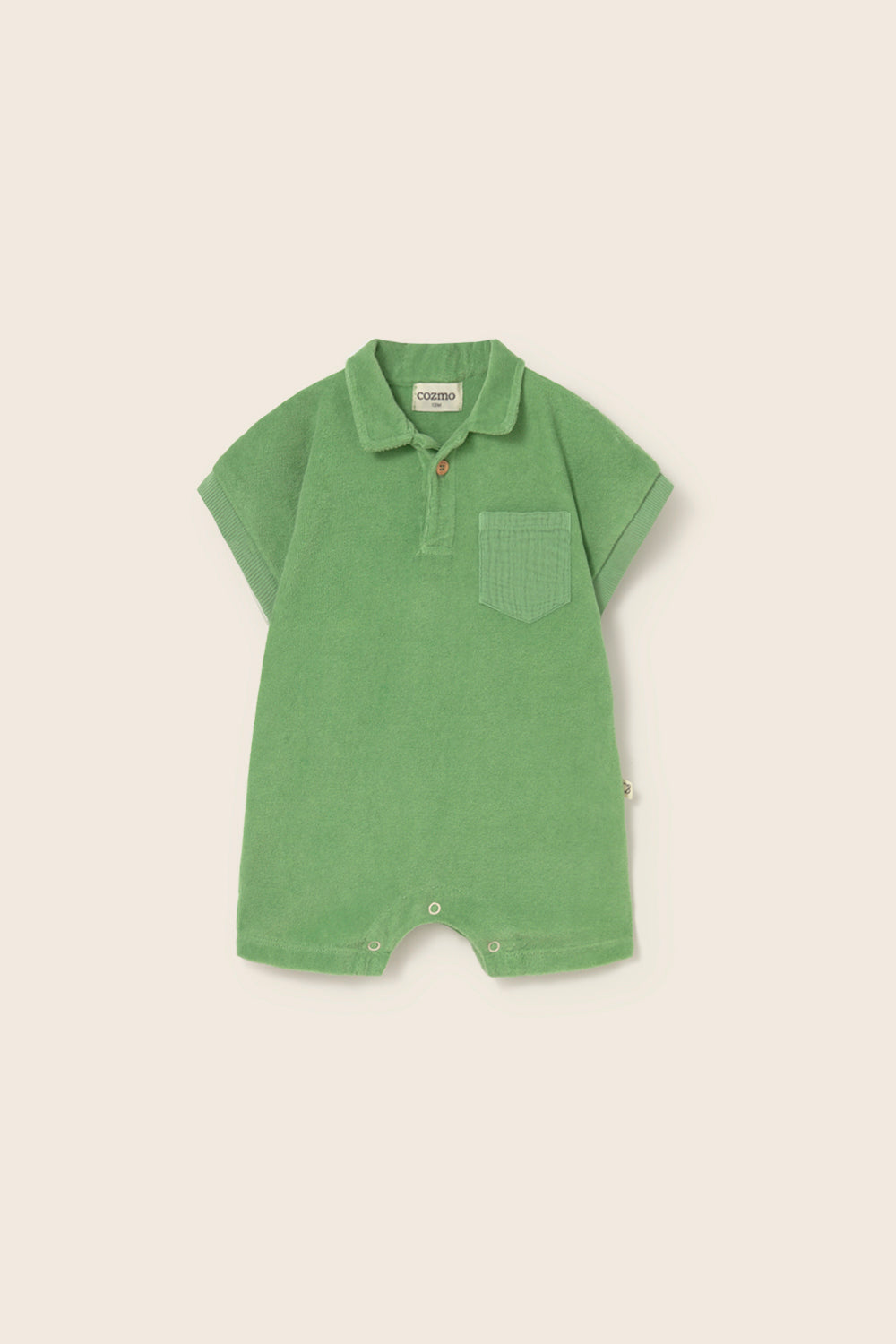 Soft cotton terry cloth baby jumpsuit with short sleeves and classic collar in neutral tones