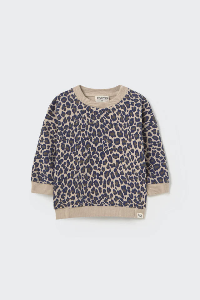 Leopard print sweater with beige trim on a light gray background