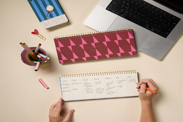 Colorful weekly planner pad with patterned design and spiral binding for desk organization
