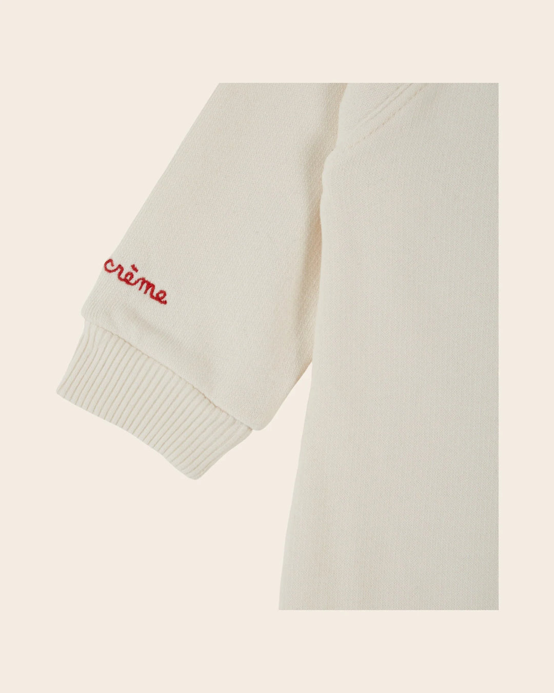 Close-up of the Emile et Ida Petit Chou baby romper in ecru, highlighting the fabric and delicate design details.