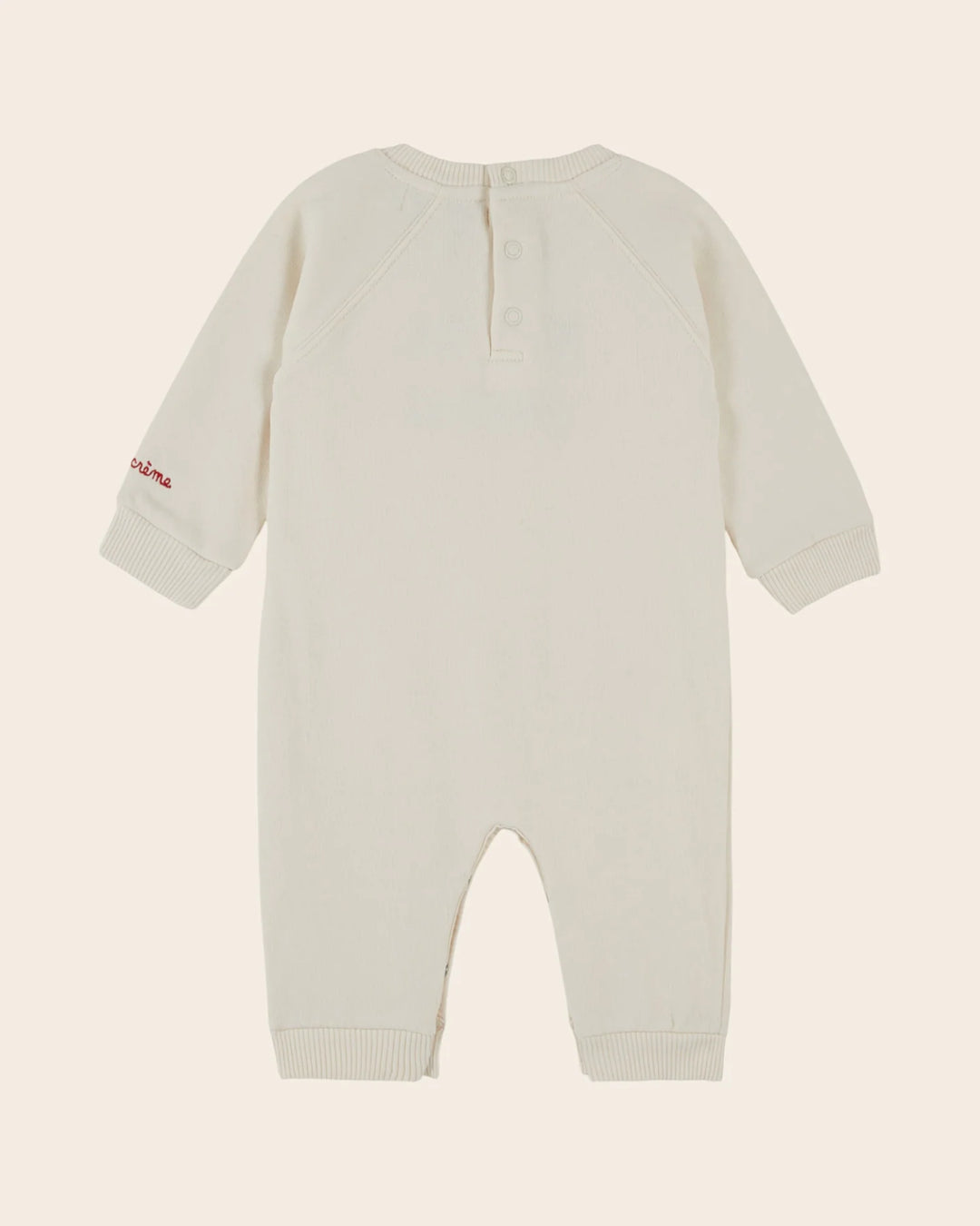 Close-up of the Emile et Ida Petit Chou baby romper in ecru, highlighting the fabric and delicate design details.