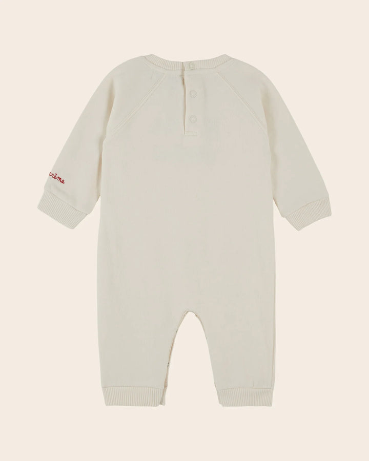 Close-up of the Emile et Ida Petit Chou baby romper in ecru, highlighting the fabric and delicate design details.