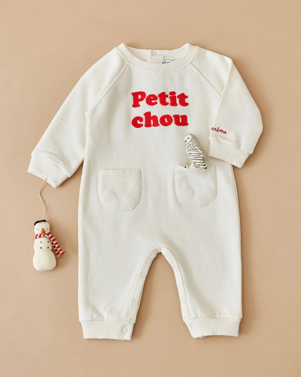 Close-up of the Emile et Ida Petit Chou baby romper in ecru, highlighting the fabric and delicate design details.
