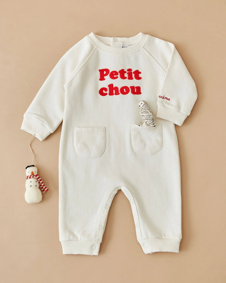 Close-up of the Emile et Ida Petit Chou baby romper in ecru, highlighting the fabric and delicate design details.