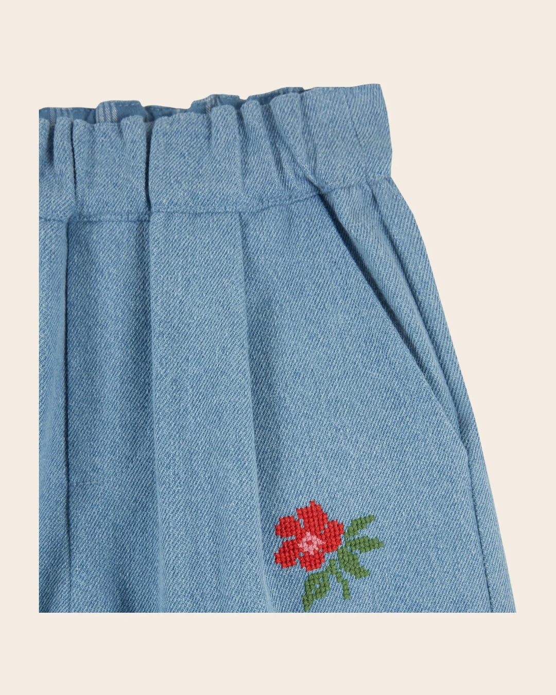 Emile et Ida girls embroidered denim pants in washed blue cotton with reinforced knee patches and a relaxed carrot fit