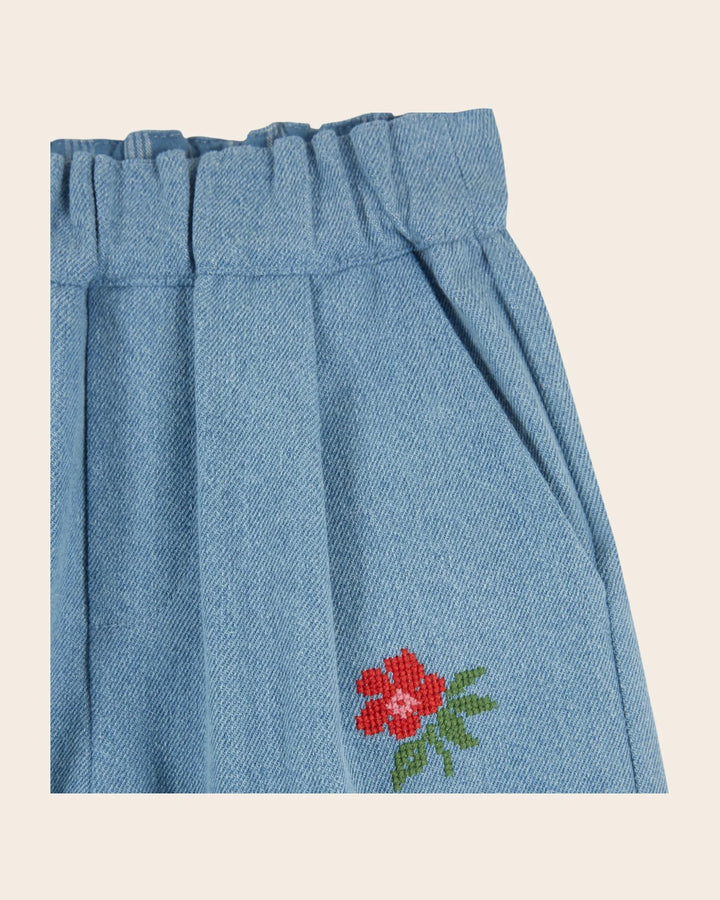 Emile et Ida girls embroidered denim pants in washed blue cotton with reinforced knee patches and a relaxed carrot fit