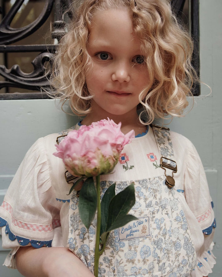 girls cream embroidered cotton blouse with blue trim
