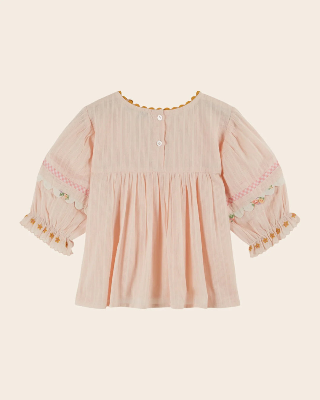 girls pink embroidered cotton blouse with blue trim
