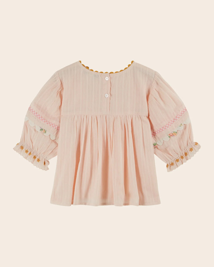 girls pink embroidered cotton blouse with blue trim
