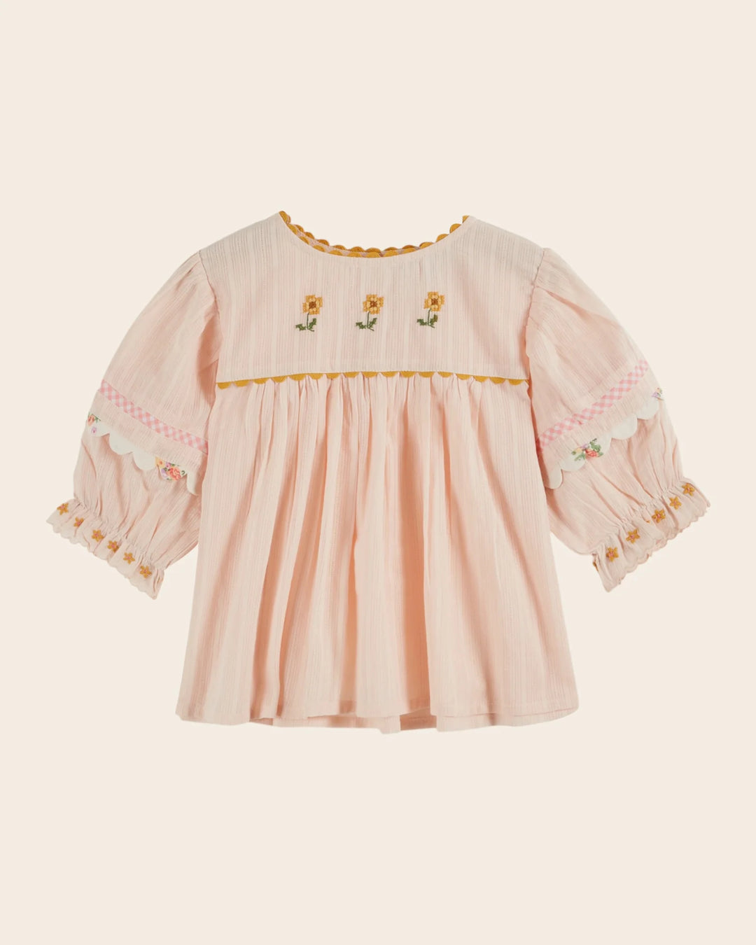 girls pink embroidered cotton blouse with blue trim
