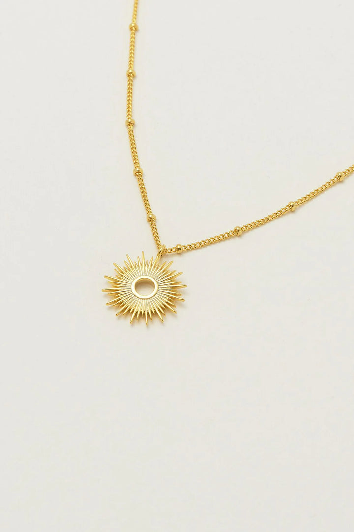 Estella Bartlett gold plated sunburst pendant necklace on delicate chain