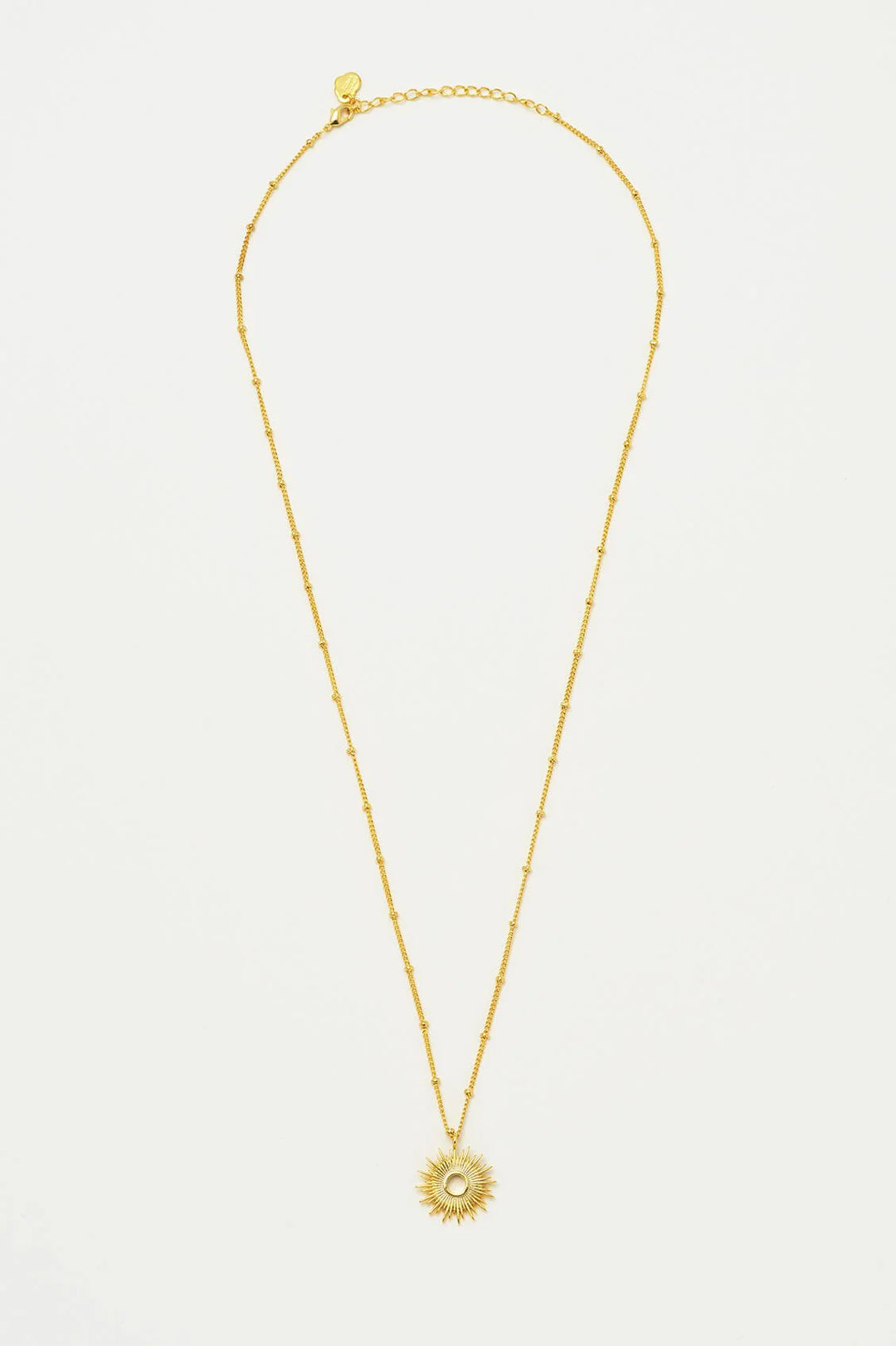 Estella Bartlett gold plated sunburst pendant necklace on delicate chain