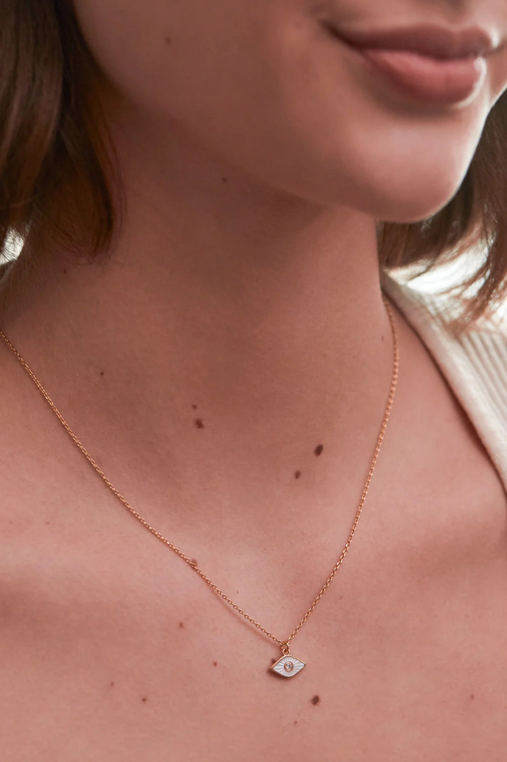 Estella Bartlett gold plated evil eye necklace with pearl detail