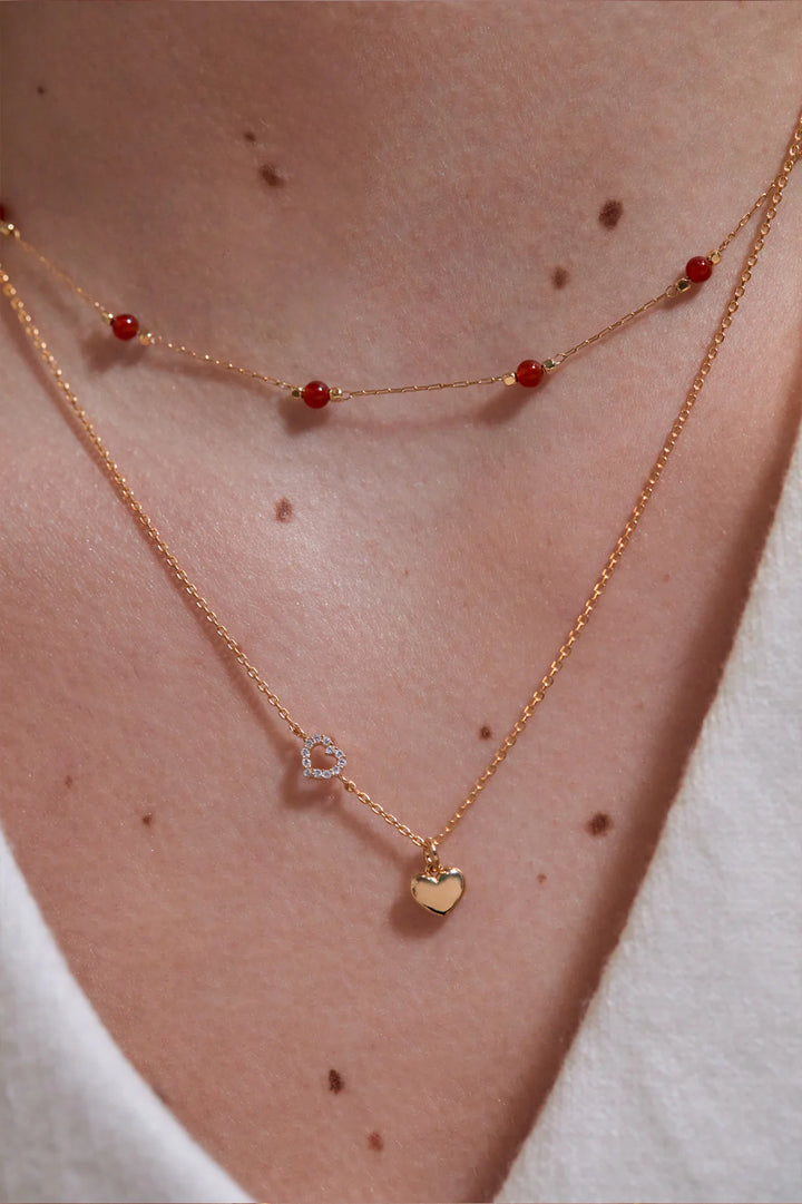 Estella Bartlett gold plated heart charm necklace with crystal heart detail