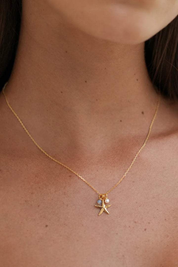 Estella Bartlett gold plated starfish charm necklace with pearl and blue agate details
