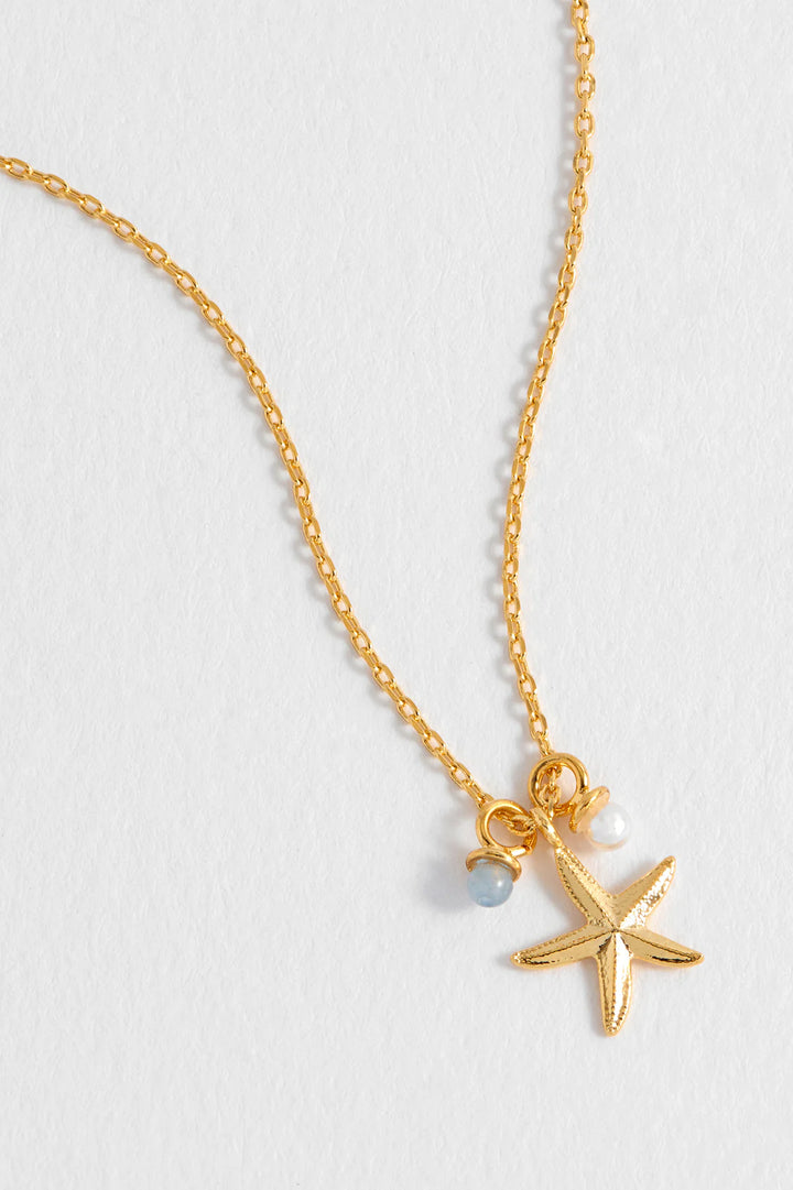 Estella Bartlett gold plated starfish charm necklace with pearl and blue agate details