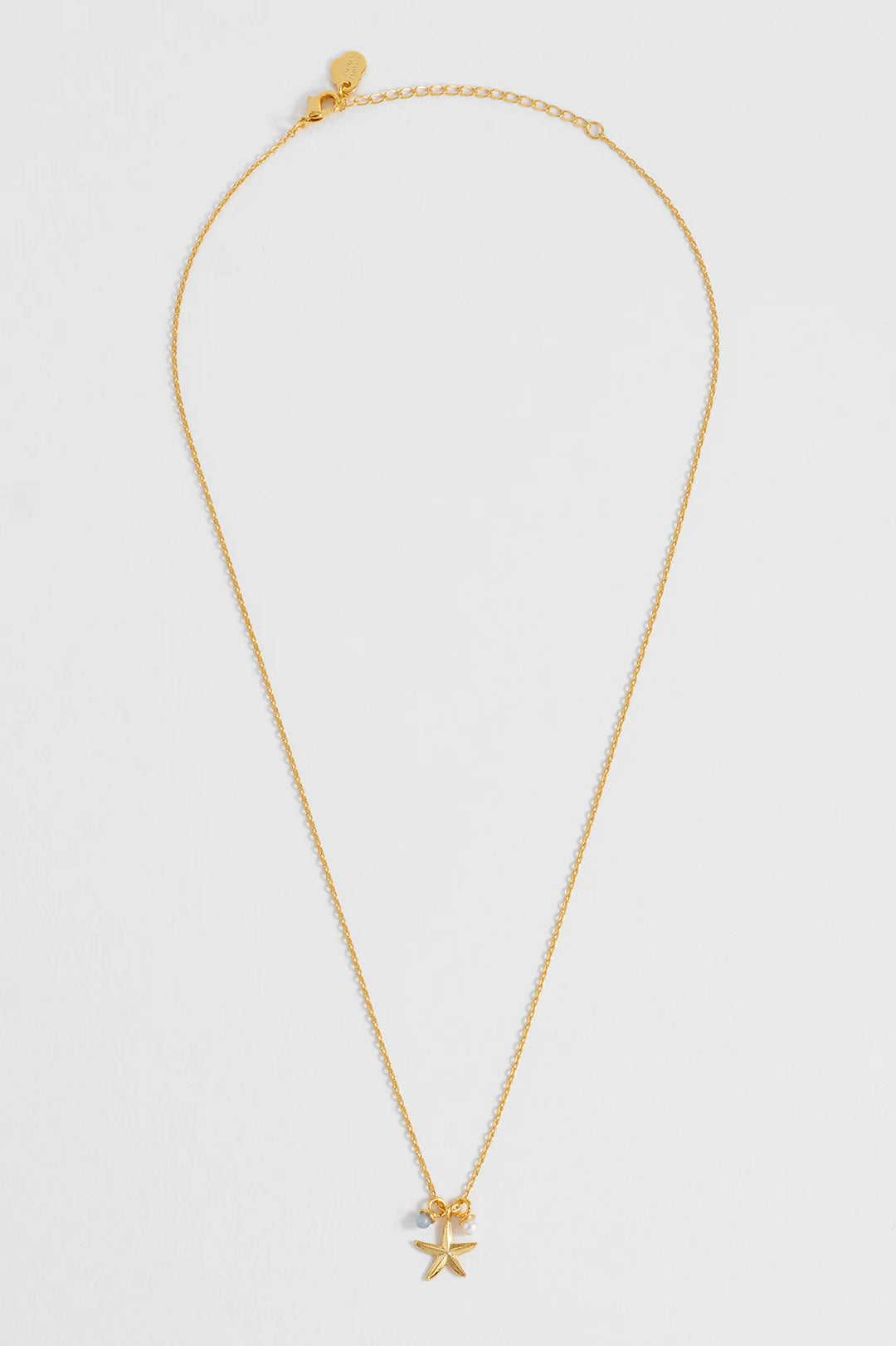 Estella Bartlett gold plated starfish charm necklace with pearl and blue agate details