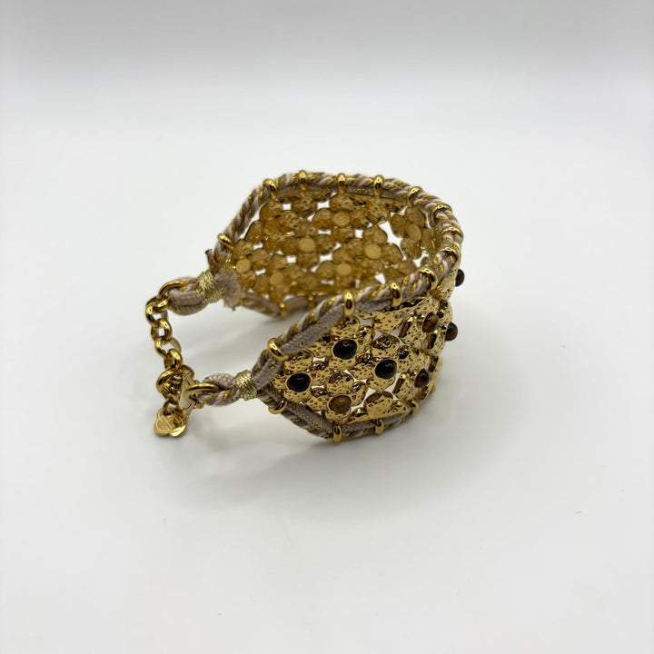 Habaha gold statement cuff bracelet with intricate floral openwork design and decorative gemstone accents