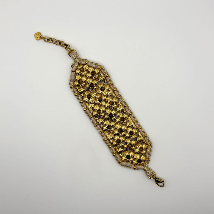Habaha gold statement cuff bracelet with intricate floral openwork design and decorative gemstone accents