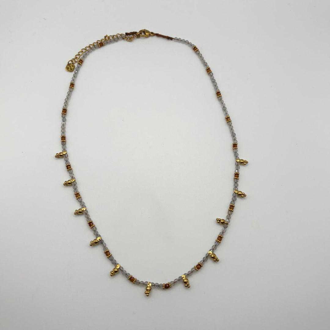 Habaha Eirlys Noura beaded necklace with soft grey stones and delicate gold dangling charms.