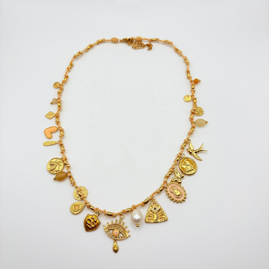 Habaha gold charm statement necklace with symbolic pendants, freshwater pearl and delicate beaded details