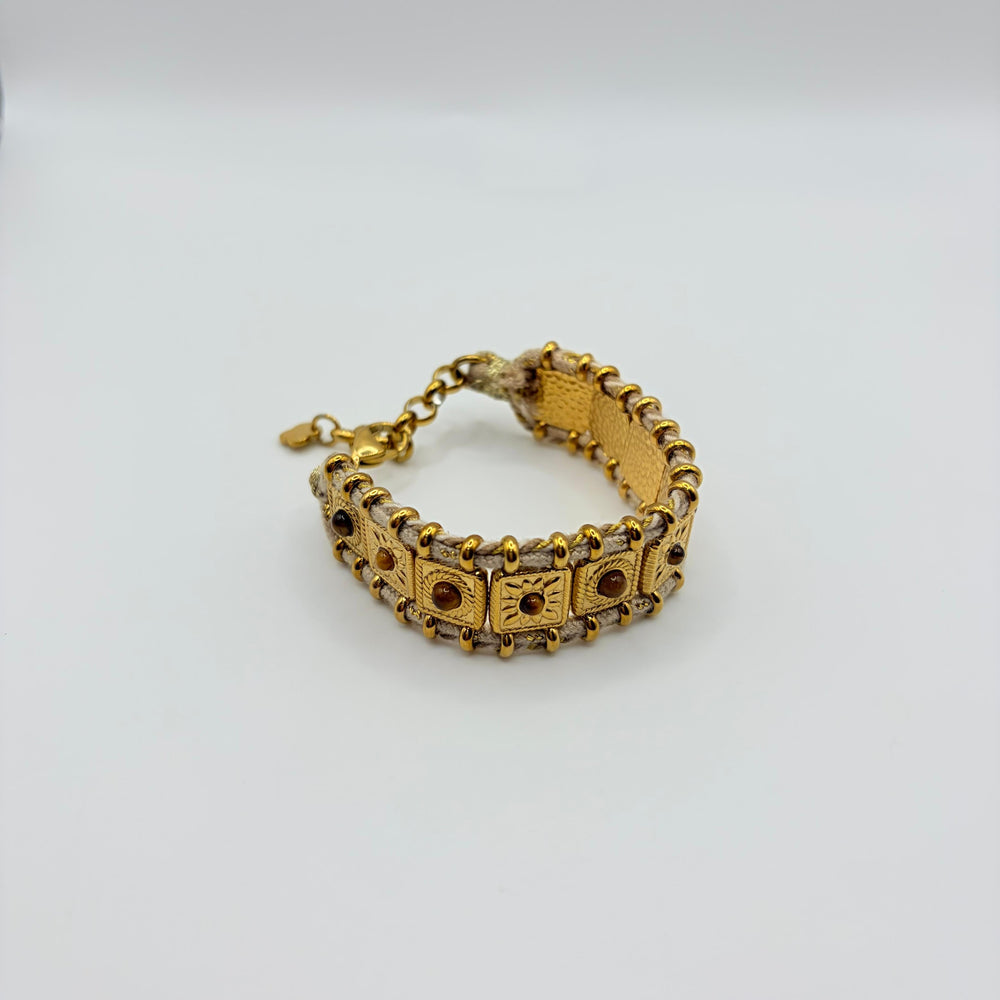Habaha gold bohemian bracelet with textured metal details, woven cord and natural stone accents